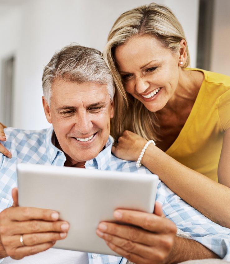 A Mature Couple Using A Digital Tablet