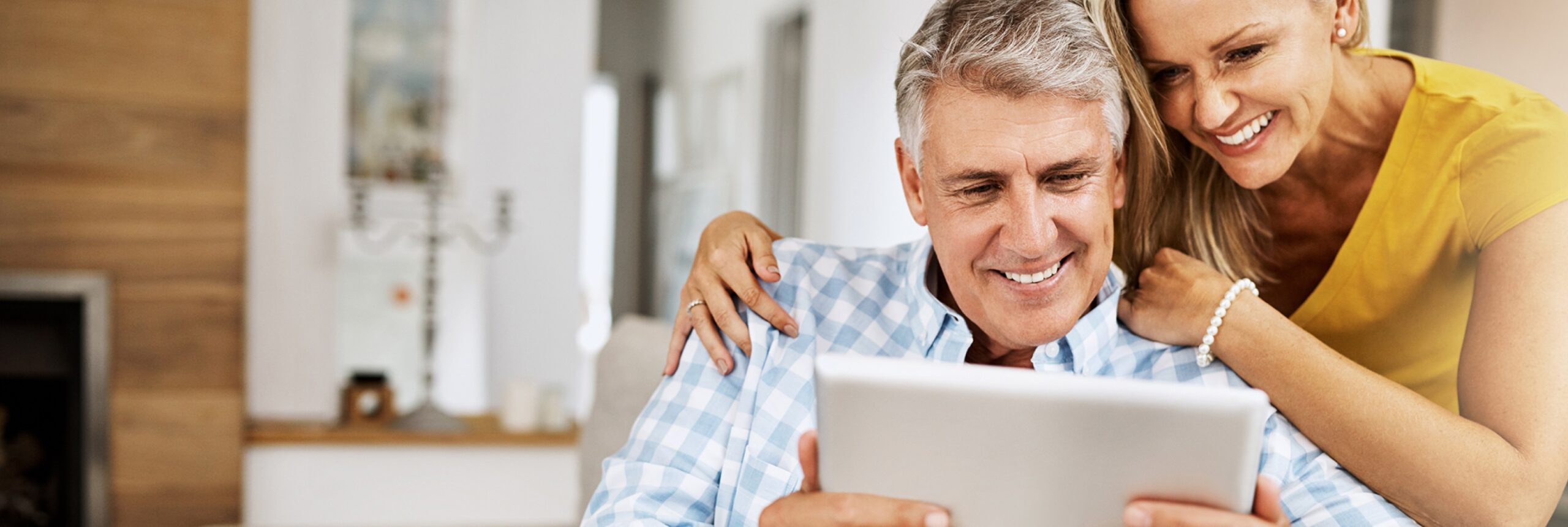 Cropped Shot Of A Mature Couple Using A Digital Tablet While Relaxing At Home