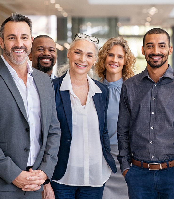 Portrait Of Successful Group Of Business People At Modern Office Looking At Camera