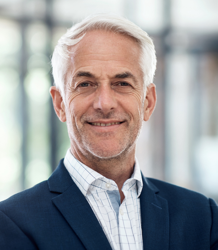 Portrait of a confident mature businessman working in a modern office